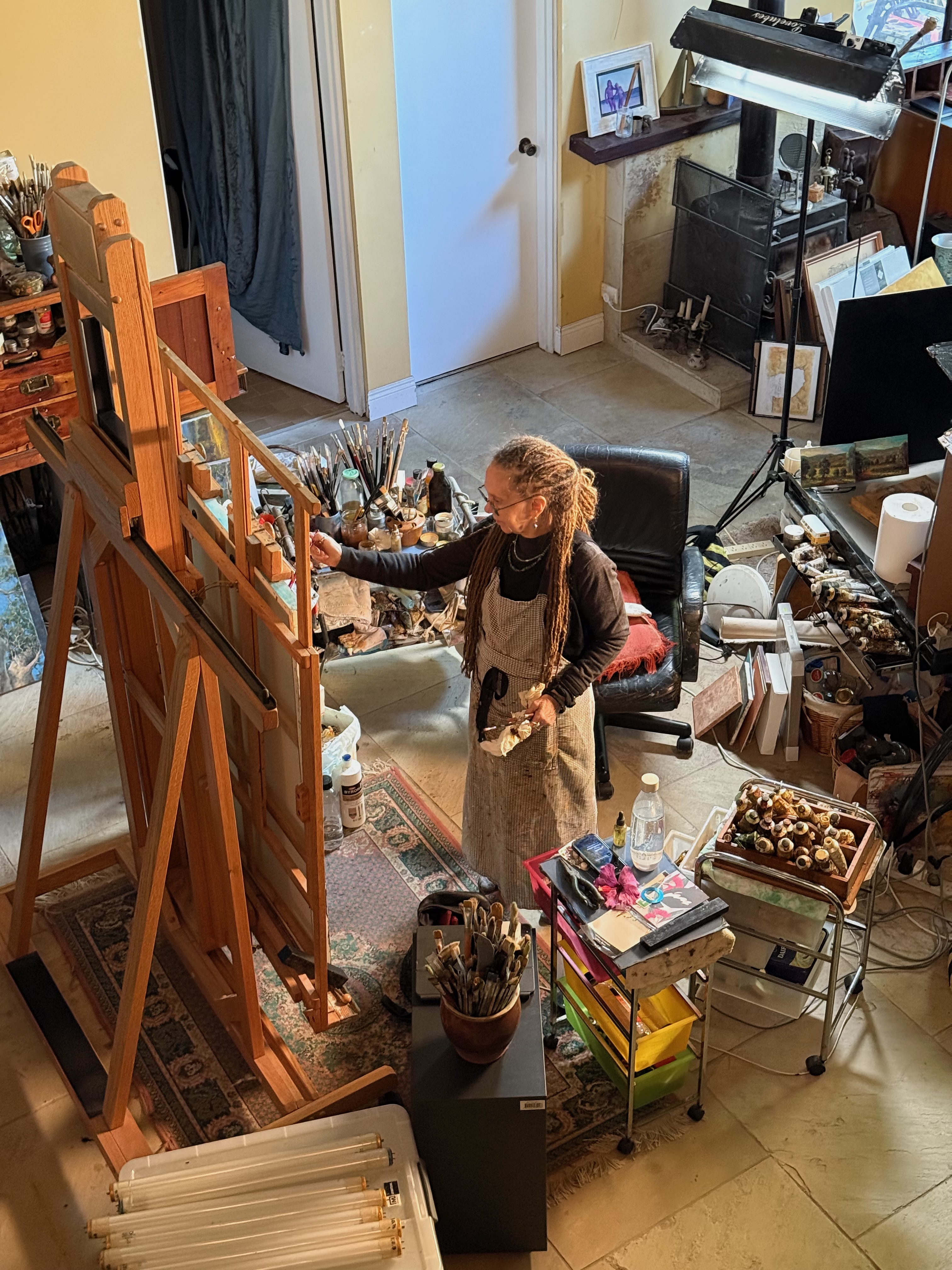 Carol D'Arcy, Australian fine art oil painter, at work in her studio at the easel — Queensland, Australia