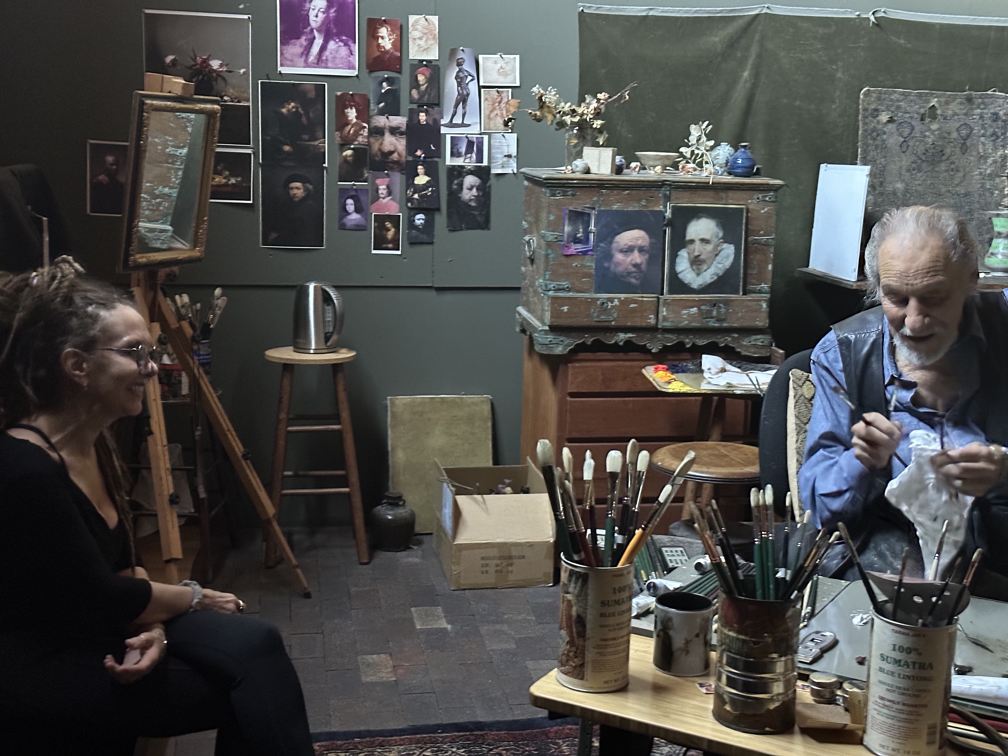Carol D'Arcy and David Leffel sharing a laugh in his studio, Arroyo Seco, New Mexico 2023. Photograph by Joe D'Arcy.
